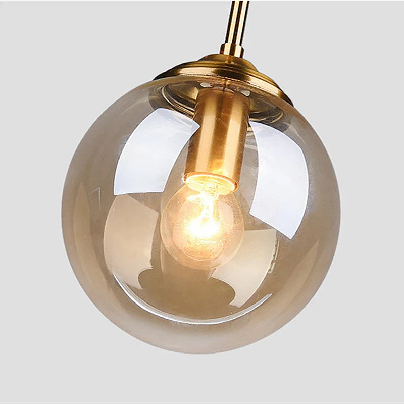Suspension luminaire design en verre teinté boule Mon Luminaire™